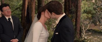 Movie still from “The Twilight Saga: Breaking Dawn - Part 1” (2011), directed by Bill Condon – A man and woman kissing in front of a forest; Close Up shot, High angle