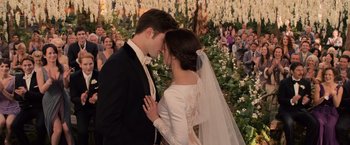 Movie still from “The Twilight Saga: Breaking Dawn - Part 1” (2011), directed by Bill Condon – A bride and groom kissing in front of a crowd; Medium shot, Over the shoulder angle