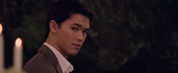 Movie still from “The Twilight Saga: Breaking Dawn - Part 1” (2011), directed by Bill Condon – A man in a suit and tie looking at the camera; Close Up shot, Over the shoulder angle