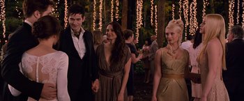 Movie still from “The Twilight Saga: Breaking Dawn - Part 1” (2011), directed by Bill Condon – A group of people standing in the woods at a party; Medium shot, Over the shoulder angle