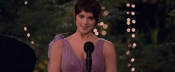 Movie still from “The Twilight Saga: Breaking Dawn - Part 1” (2011), directed by Bill Condon – A woman in a purple dress is speaking into a microphone; Close Up shot, Over the shoulder angle