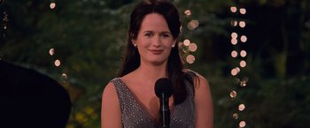 Movie still from “The Twilight Saga: Breaking Dawn - Part 1” (2011), directed by Bill Condon – A beautiful woman standing in front of a microphone; Close Up shot, Over the shoulder angle