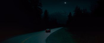 Movie still from “The Twilight Saga: Breaking Dawn - Part 1” (2011), directed by Bill Condon – A car driving down a road at night with a full moon in the background; Extreme Wide shot, High angle