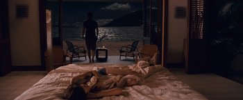 Movie still from “The Twilight Saga: Breaking Dawn - Part 1” (2011), directed by Bill Condon – A woman laying on a bed in front of the ocean; Wide shot, High angle