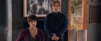 Movie still from “The Twilight Saga: Breaking Dawn - Part 1” (2011), directed by Bill Condon – A man and a woman standing next to each other in front of a fireplace; Medium shot, Over the shoulder angle