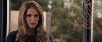 Movie still from “The Twilight Saga: Breaking Dawn - Part 1” (2011), directed by Bill Condon – A beautiful woman with long brown hair standing in front of trees; Close Up shot, Over the shoulder angle