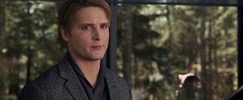 Movie still from “The Twilight Saga: Breaking Dawn - Part 1” (2011), directed by Bill Condon – A man in a suit and tie standing in front of a window; Close Up shot, Over the shoulder angle