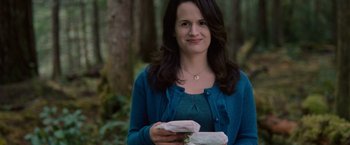 Movie still from “The Twilight Saga: Breaking Dawn - Part 1” (2011), directed by Bill Condon – A woman holding a sandwich while standing in the woods; Close Up shot, Over the shoulder angle