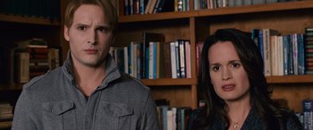 Movie still from “The Twilight Saga: Breaking Dawn - Part 1” (2011), directed by Bill Condon – A man and a woman standing next to each other in front of a book shelf; Close Up shot, Low angle