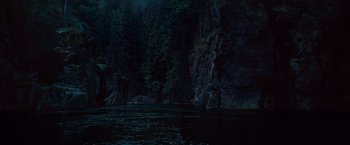 Movie still from “The Twilight Saga: Breaking Dawn - Part 1” (2011), directed by Bill Condon – A body of water surrounded by trees and rocks at night time; Extreme Wide shot, High angle