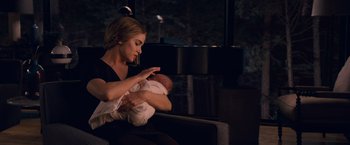 Movie still from “The Twilight Saga: Breaking Dawn - Part 1” (2011), directed by Bill Condon – A woman holding a baby in her arms; Medium shot, Over the shoulder angle