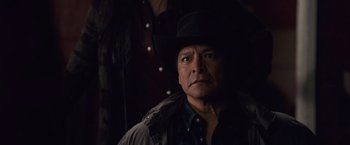 Movie still from “The Twilight Saga: Breaking Dawn - Part 1” (2011), directed by Bill Condon – A man wearing a black hat and a black jacket; Close Up shot, Over the shoulder angle