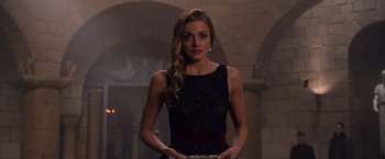 Movie still from “The Twilight Saga: Breaking Dawn - Part 1” (2011), directed by Bill Condon – A beautiful woman in a black dress holding something in her hands; Medium shot, Over the shoulder angle