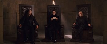 Movie still from “The Twilight Saga: Breaking Dawn - Part 1” (2011), directed by Bill Condon – A group of people sitting on top of a wooden chair; Medium shot, Low angle