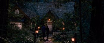 Movie still from “The Twilight Saga: Breaking Dawn - Part 2” (2012), directed by Bill Condon – Two people walking down a path in front of a house at night; Wide shot, High angle