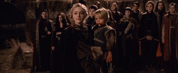 Movie still from “The Twilight Saga: Breaking Dawn - Part 2” (2012), directed by Bill Condon – A woman and a child are standing in front of a group of people; Medium shot, High angle