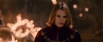 Movie still from “The Twilight Saga: Breaking Dawn - Part 2” (2012), directed by Bill Condon – A woman in a red jacket is looking at the camera; Close Up shot, Over the shoulder angle