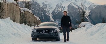 Movie still from “The Twilight Saga: Breaking Dawn - Part 2” (2012), directed by Bill Condon – A man standing next to a car in the snow; Wide shot, Low angle