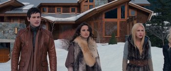 Movie still from “The Twilight Saga: Breaking Dawn - Part 2” (2012), directed by Bill Condon – A woman standing in front of a house in the snow; Medium shot, High angle
