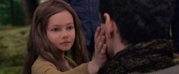 Movie still from “The Twilight Saga: Breaking Dawn - Part 2” (2012), directed by Bill Condon – A young girl looking at a young man with his hand over her ear; Close Up shot, Over the shoulder angle