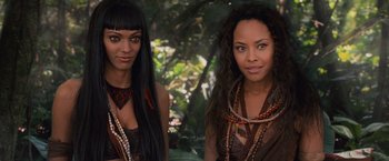 Movie still from “The Twilight Saga: Breaking Dawn - Part 2” (2012), directed by Bill Condon – Two beautiful women standing next to each other in a forest; Close Up shot, High angle