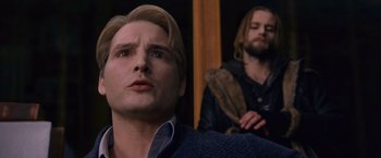 Movie still from “The Twilight Saga: Breaking Dawn - Part 2” (2012), directed by Bill Condon – A man with blonde hair is looking at the camera while another man with long blonde hair looks at the camera; Close Up shot, Low angle