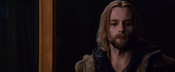 Movie still from “The Twilight Saga: Breaking Dawn - Part 2” (2012), directed by Bill Condon – A man with long blonde hair sitting in front of a mirror; Close Up shot, Over the shoulder angle