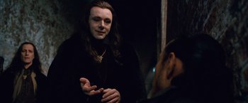 Movie still from “The Twilight Saga: Breaking Dawn - Part 2” (2012), directed by Bill Condon – A man with long hair talking to another man in a dark room; Close Up shot, Over the shoulder angle
