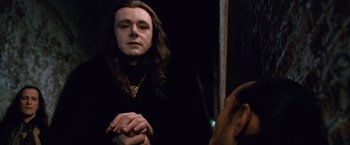 Movie still from “The Twilight Saga: Breaking Dawn - Part 2” (2012), directed by Bill Condon – A man with long black hair is looking at himself in the mirror; Close Up shot, Over the shoulder angle