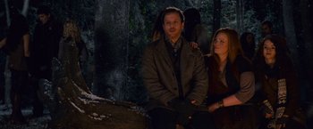 Movie still from “The Twilight Saga: Breaking Dawn - Part 2” (2012), directed by Bill Condon – A man and a woman sitting in front of a tree; Medium shot, Over the shoulder angle