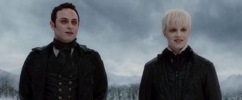 Movie still from “The Twilight Saga: Breaking Dawn - Part 2” (2012), directed by Bill Condon – Two men standing next to each other in front of trees; Close Up shot, Low angle