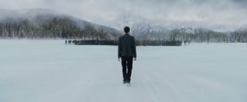 Movie still from “The Twilight Saga: Breaking Dawn - Part 2” (2012), directed by Bill Condon – A man is walking through the snow towards a mountain; Extreme Wide shot, High angle