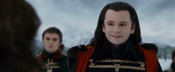 Movie still from “The Twilight Saga: Breaking Dawn - Part 2” (2012), directed by Bill Condon – A man with long black hair and a cross on his chest; Close Up shot, Over the shoulder angle