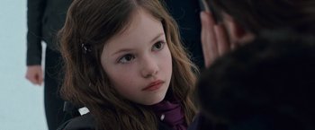 Movie still from “The Twilight Saga: Breaking Dawn - Part 2” (2012), directed by Bill Condon – A young girl looking at the camera while wearing a purple scarf; Close Up shot, Over the shoulder angle