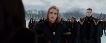 Movie still from “The Twilight Saga: Breaking Dawn - Part 2” (2012), directed by Bill Condon – A woman in a black coat is in front of a group of people; Medium shot, Over the shoulder angle