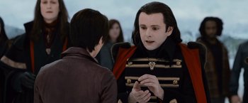 Movie still from “The Twilight Saga: Breaking Dawn - Part 2” (2012), directed by Bill Condon – A man with long black hair talking to another man; Close Up shot, Over the shoulder angle