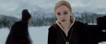 Movie still from “The Twilight Saga: Breaking Dawn - Part 2” (2012), directed by Bill Condon – A woman in a black and white outfit with a necklace; Close Up shot, Over the shoulder angle