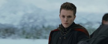 Movie still from “The Twilight Saga: Breaking Dawn - Part 2” (2012), directed by Bill Condon – A young man wearing a chain around his neck; Close Up shot, Over the shoulder angle