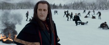 Movie still from “The Twilight Saga: Breaking Dawn - Part 2” (2012), directed by Bill Condon – A man with long black hair standing in the middle of a snow covered field; Close Up shot, Over the shoulder angle