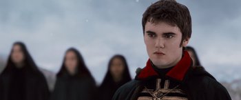 Movie still from “The Twilight Saga: Breaking Dawn - Part 2” (2012), directed by Bill Condon – A young man in a black and red outfit; Close Up shot, Over the shoulder angle