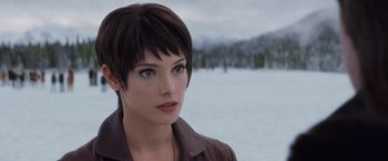 Movie still from “The Twilight Saga: Breaking Dawn - Part 2” (2012), directed by Bill Condon – A woman with short black hair wearing a brown jacket; Close Up shot, Over the shoulder angle