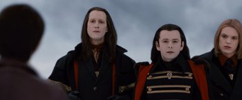 Movie still from “The Twilight Saga: Breaking Dawn - Part 2” (2012), directed by Bill Condon – Two men dressed up like vampires standing next to each other; Close Up shot, Low angle