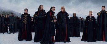 Movie still from “The Twilight Saga: Breaking Dawn - Part 2” (2012), directed by Bill Condon – A group of men in black and red costumes; Medium shot, Low angle