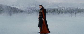Movie still from “The Twilight Saga: Breaking Dawn - Part 2” (2012), directed by Bill Condon – A man dressed in a uniform standing in the middle of a snow covered field; Medium shot, Low angle