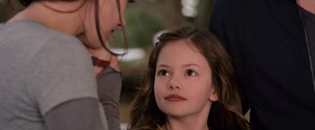 Movie still from “The Twilight Saga: Breaking Dawn - Part 2” (2012), directed by Bill Condon – A young girl with long hair looking up at a woman; Close Up shot, Over the shoulder angle