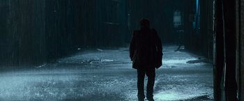 Movie still from “The Twilight Saga: Eclipse” (2010), directed by David Slade – A person walking in the rain on a wet street; Wide shot, Low angle