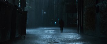 Movie still from “The Twilight Saga: Eclipse” (2010), directed by David Slade – A person walking in the rain on a street; Extreme Wide shot, High angle