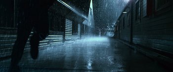 Movie still from “The Twilight Saga: Eclipse” (2010), directed by David Slade – A street with a building on the side of the street and a person walking on the sidewalk in front of it; Extreme Wide shot, Low angle