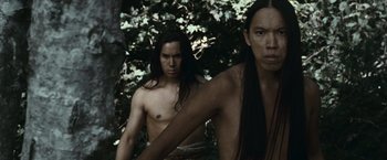 Movie still from “The Twilight Saga: Eclipse” (2010), directed by David Slade – Two native american men standing next to each other in the woods; Medium shot, Low angle