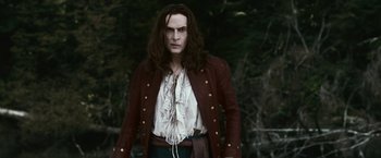 Movie still from “The Twilight Saga: Eclipse” (2010), directed by David Slade – A man with long black hair wearing a red jacket; Medium shot, Over the shoulder angle